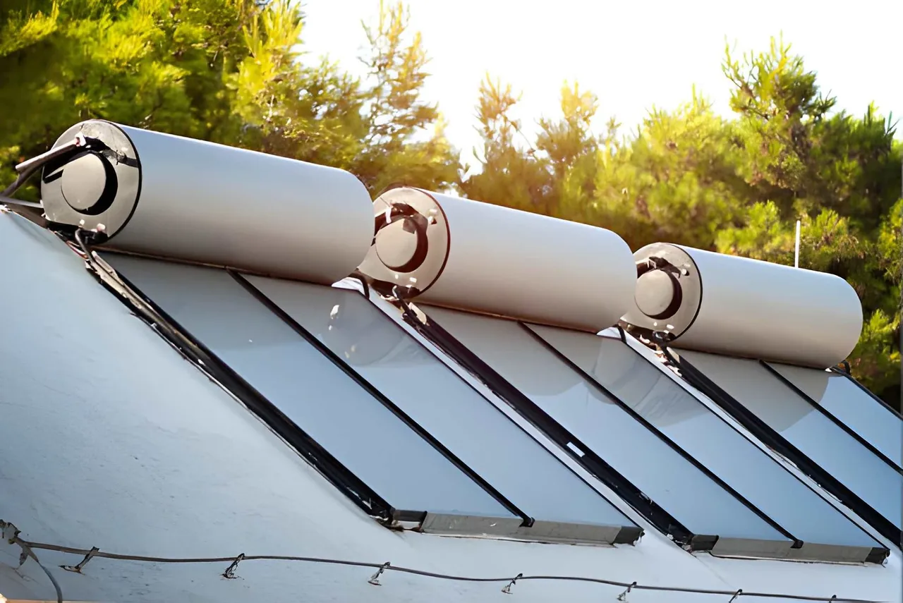 Solar thermal water heater with collector panels and storage tank on a rooftop
